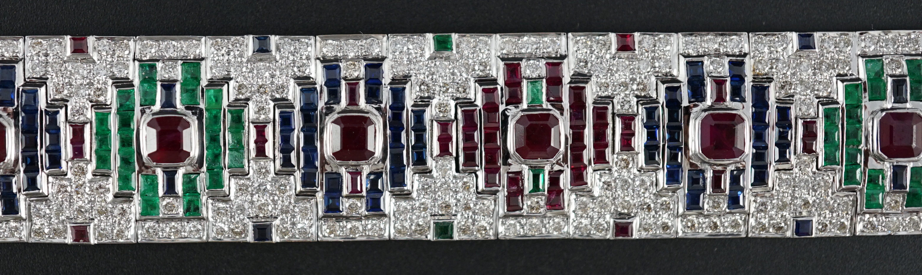 An attractive late 20th century 18k white gold, ruby, sapphire, emerald and diamond set bracelet